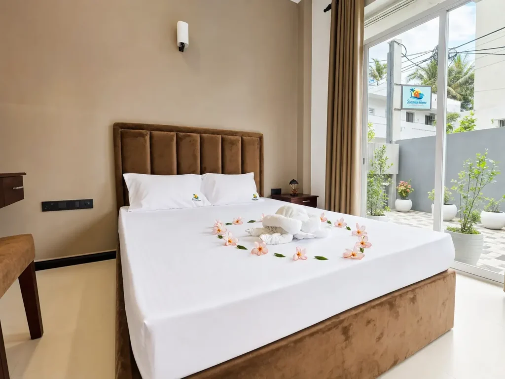 Double room with white bedding, wooden furniture and a bright window