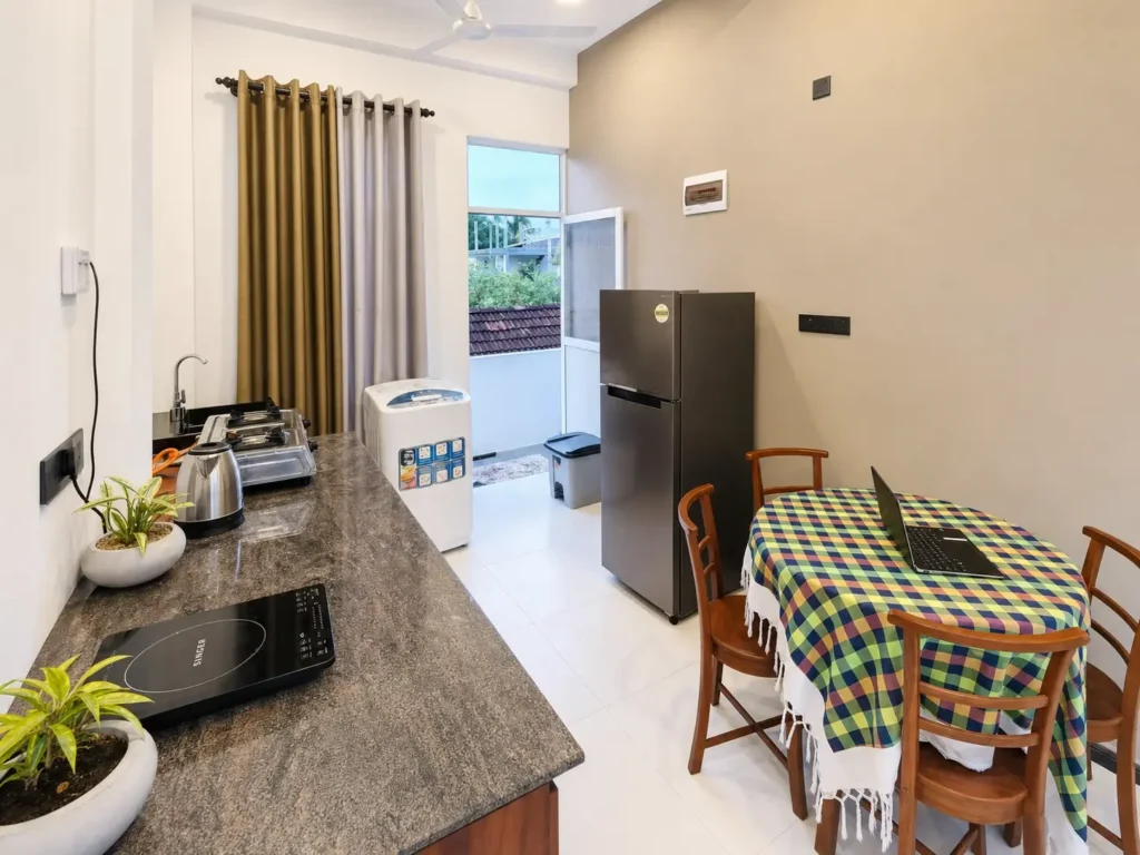 Kitchen and dining area with a refrigerator and table