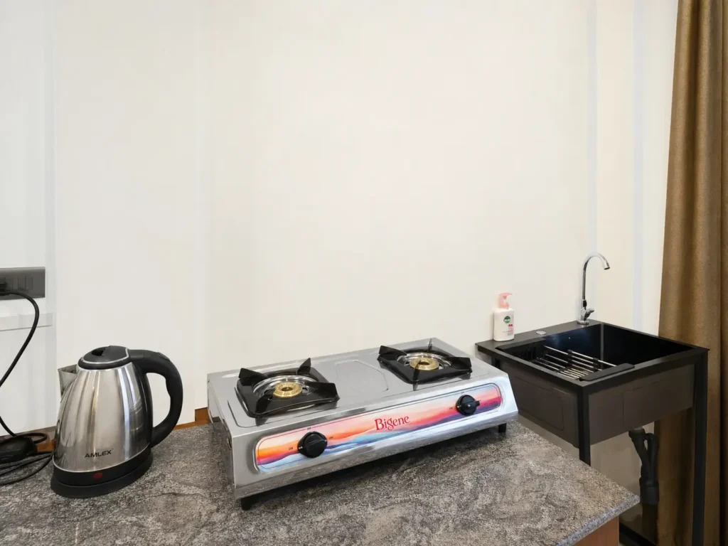 Kitchen counter with kettle, hob and sink